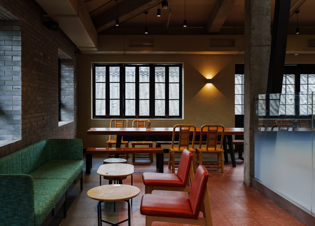 A beautifully preserved historic brick building housing a modern cafe with outdoor seating, blending old-world charm with contemporary lifestyle.