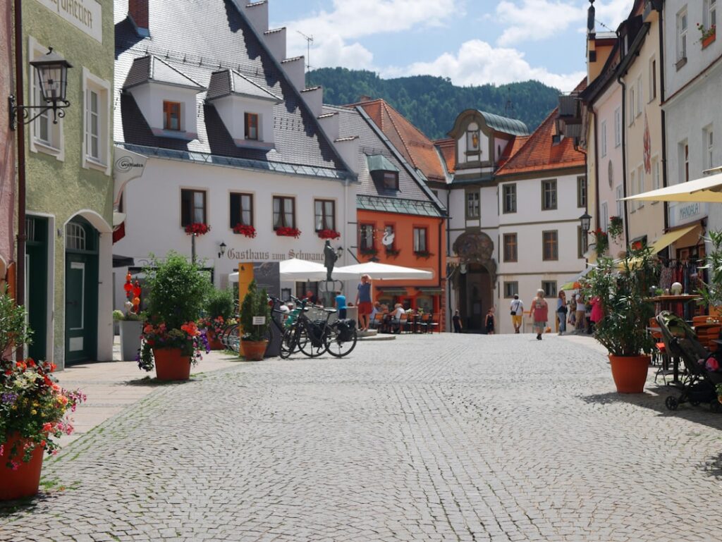 Bright, sunny day on a charming main street lined with local shops and boutiques, showcasing a walkable urban neighborhood.