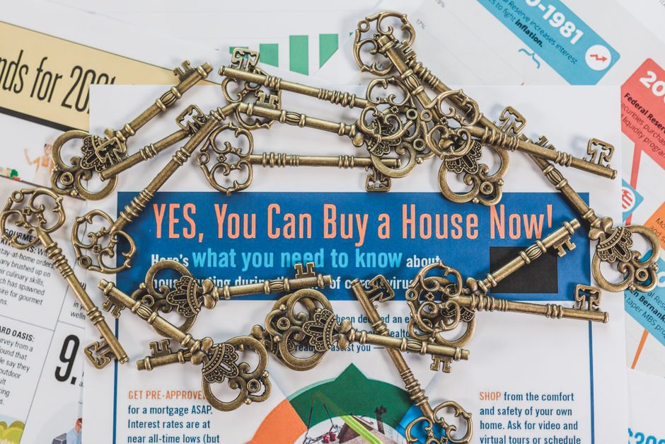 Pair of hands gently holding a set of old-fashioned, vintage house keys, symbolizing the inheritance of a family home.