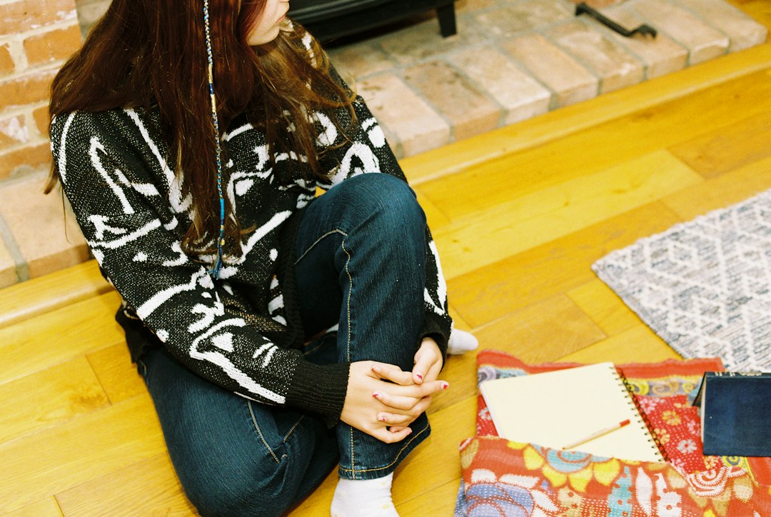 A person hurriedly tidies up a lived-in living room, symbolizing the chaotic rush to prepare for an unexpected home showing.